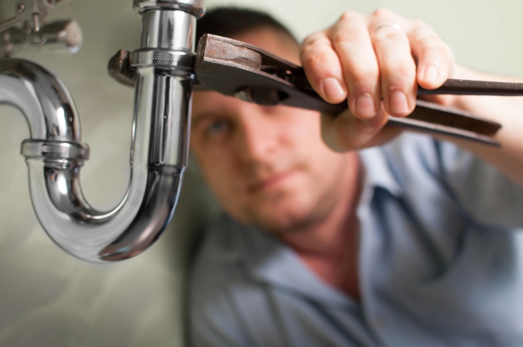 Man fixing a sink pipe